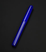Load image into Gallery viewer, A translucent royal blue pen with a matching cap, shown diagonally on a dark black background.