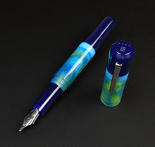 Load image into Gallery viewer, A Franklin-Christoph Model 19 Kingston SE blue-green fountain pen uncapped on a black surface.