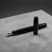 Load image into Gallery viewer, Franklin-Christoph Model 46L fountain pen in black acrylic with a maroon finial. Features a silver nib and cap.