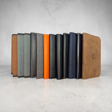 Load image into Gallery viewer, Franklin-Christoph 5.3 pocket notebook covers in various colors and materials including brown leather, grey canvas, and black leather.