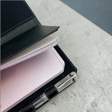 Load image into Gallery viewer, Franklin-Christoph black leather Command Center Padfolio with tan stitching, pen slot, and notepad.