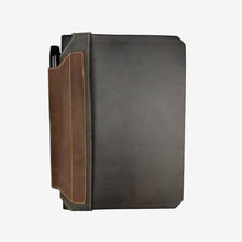 Load image into Gallery viewer, Franklin-Christoph black and brown leather elastic pen holder attached to a hardcover notebook.