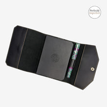 Load image into Gallery viewer, Franklin-Christoph black FxCel leather A6 snap notebook cover with creme stitching, pen loop, and interior pockets. Includes a grey notebook.