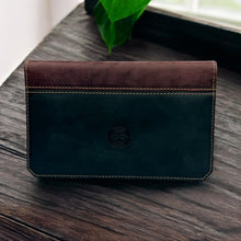Load image into Gallery viewer, Franklin-Christoph two-tone boot leather checkbook cover in dark green and brown, featuring a Celtic knot emblem.