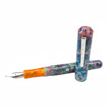 Load image into Gallery viewer, Franklin-Christoph Model 31 Omnis fountain pen with a colorful acrylic barrel and cap, featuring an orange grip section and silver clip.